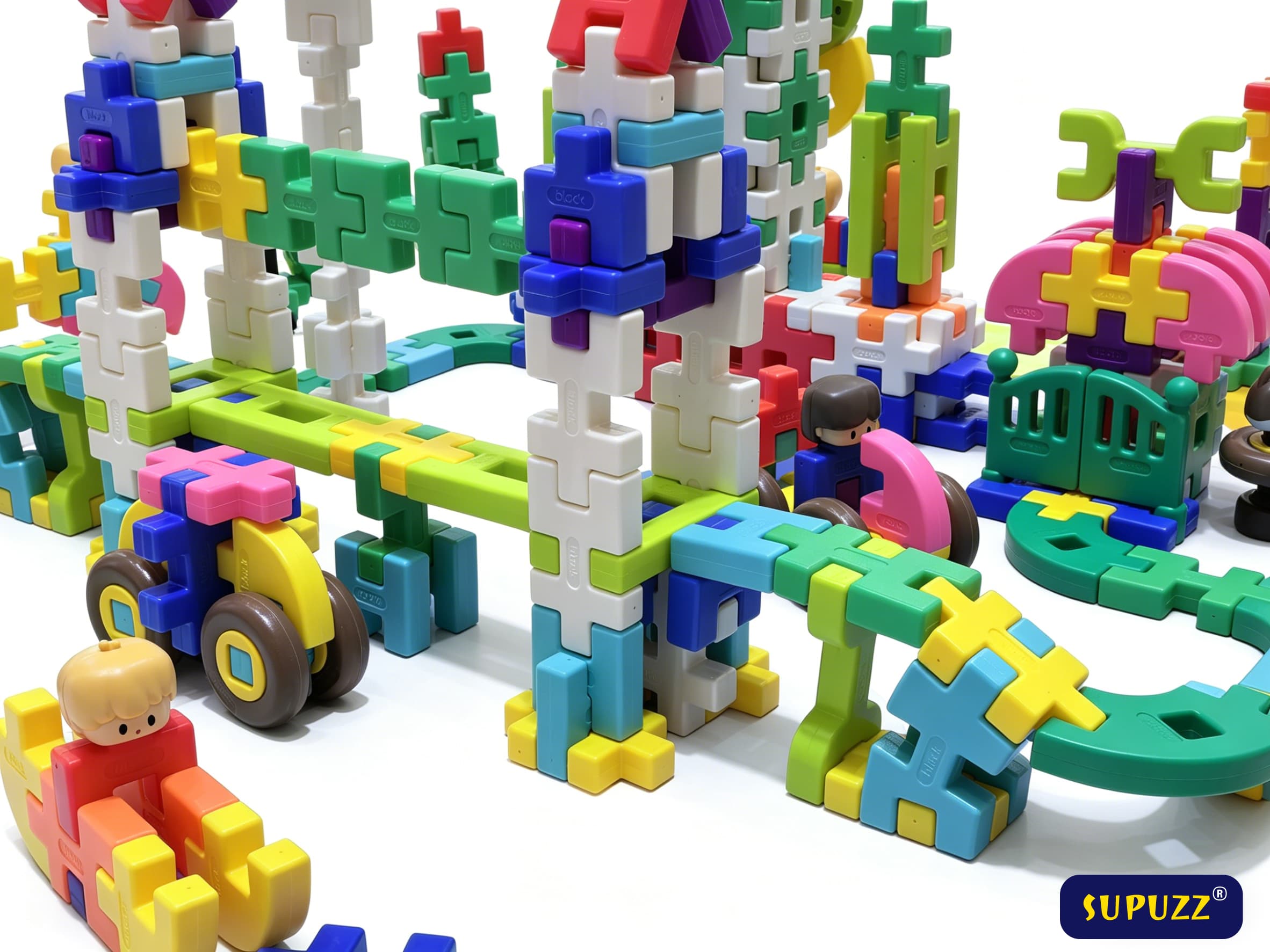 SUPUZZ premium waffle-style building blocks built into towers, vehicles, and playful scenes on a white background